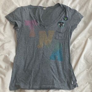 TNA Gray V neck tee with Multicolor Graphic, fits small says its L
